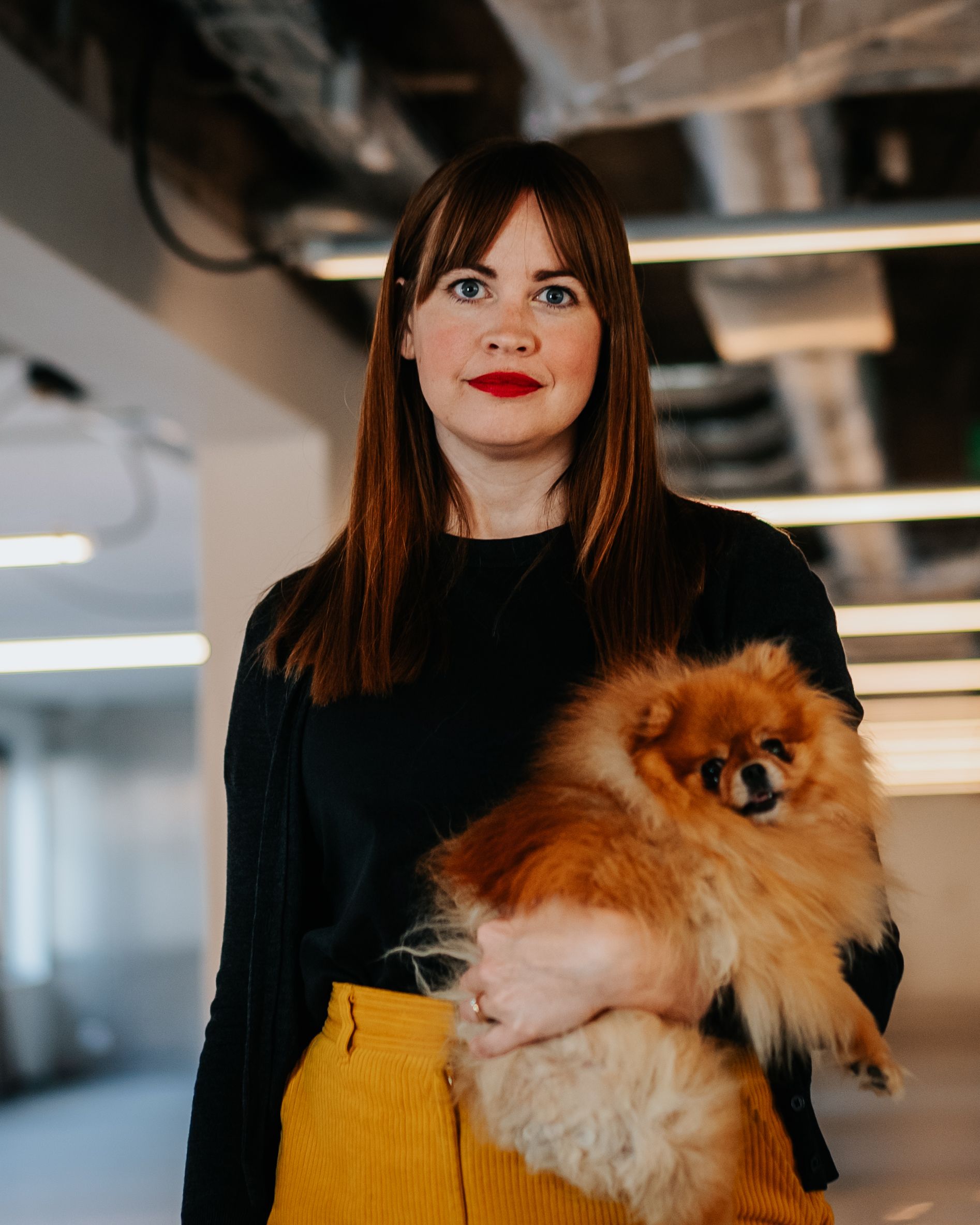 Standing person holding a dog
